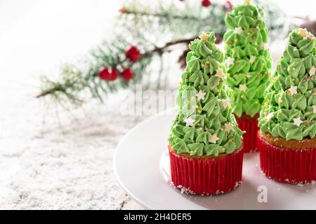 Christmas tree cupcakes isolated on white background Stock Photo