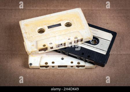 Three Old Audio Cassettes on the Cardboard Background closeup Stock Photo