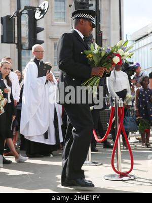 Wayne Marques, the British Transport Police officer seriously injured fighting off the London Bridge attackers, lays flowers during a ceremony to mark the one year anniversary in memory of the victims of the London Bridge/Borough Market. Picture date: Sunday June 3, 2018 Stock Photo