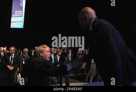 Prime Minister Boris Johnson (left) shakes hands with Chancellor of the Exchequer Sajid Javid following his speech during the second day of the Conservative Party Conference being held at the Manchester Convention Centre. Picture dated: Monday September 30, 2019. Photo credit should read: Isabel Infantes / EMPICS Entertainment. Stock Photo