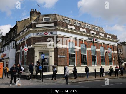 People queue outside a branch of HSBC Bank in East Ham, east London, as the UK continues in lockdown to help curb the spread of the coronavirus. Picture date: Tuesday April 28, 2020.  Stock Photo