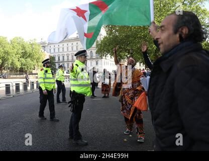 Demonstrators protest against French interference in Cameroon domestic affairs in front of the French President Emmanuel Macron while he was attending an official event with British Prime Minister Boris Johnson during his visit to the UK to mark the 80th anniversary of French Resistance leader Charles de Gaulleâ€™s wartime broadcast. Picture date: Thursday June 18, 2020. Stock Photo