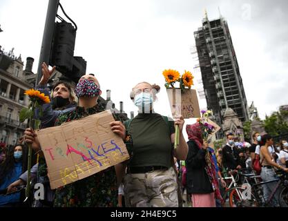 People wearing protective face masks take part at a Black Trans Lives Matter at Parliament Square, London, on the day Pride in London was due to take place, following a raft of Black Lives Matter protests across the UK. Picture date: Saturday June 27, 2020. Stock Photo