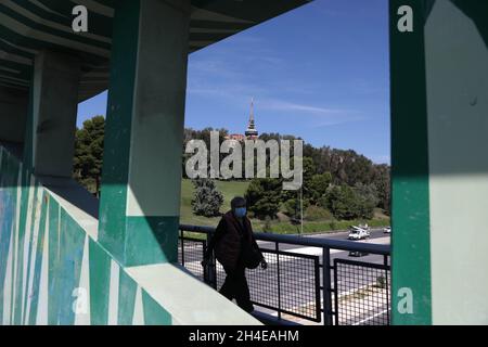 A woman wearing face covering walks through a footbridge in Madrid, as the capital registers more than a third of the 716,481 coronavirus cases diagnosed in Spain. Picture date: Monday September 28, 2020. Stock Photo