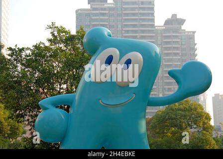 Shanghai, China: A statue of Haibao, the mascot of the Shanghai World Expo 2010. Haibao is light blue with large eyes and is waving. Stock Photo