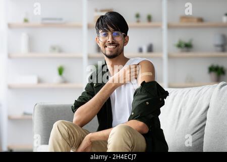 Cheerful middle eastern man got vaccinated against COVID-19 Stock Photo