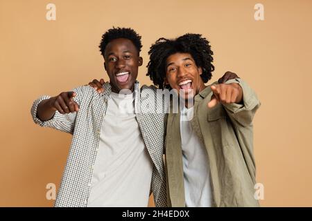 Two Cheerful Black Guys Poiting At Camera And Saying Gotcha Stock Photo