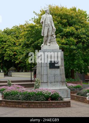 Captain James Cook statue; circumnavigator, marble, 1932, sculptor William Trethewey, public art, flower bed, park, Victoria Square, South Island; Chr Stock Photo