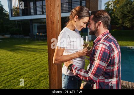 Handsome man hugging his girlfriend while resting in the outdoors Stock Photo