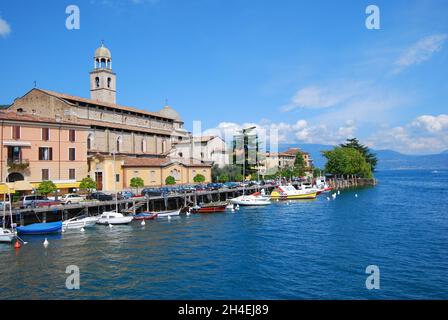 Port promenade with look at the cathedral Santa Maria Annunziata, Salo, Lake Garda. Italy, Europe Stock Photo