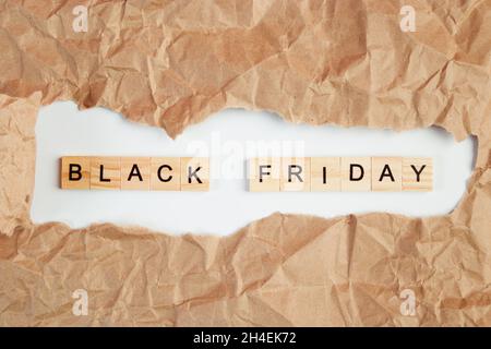 Black Friday sale. Text in torn crumpled craft paper. Stock Photo
