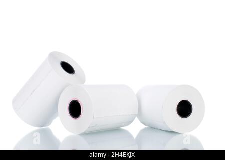 Three rolls of paper cash register tape, close-up isolated on white. Stock Photo