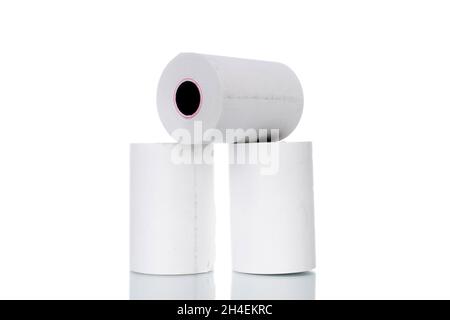 Three rolls of paper cash register tape, close-up isolated on white. Stock Photo