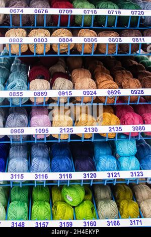 Set of multi-colored threads for embroidery and knitting. Selling sewing supplies in a hobby store. Stock Photo