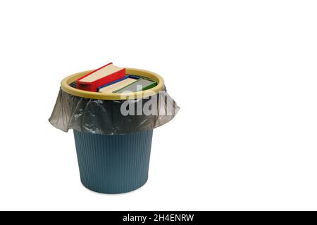 Trash can and the books thrown into it, on a white background, are isolated Stock Photo