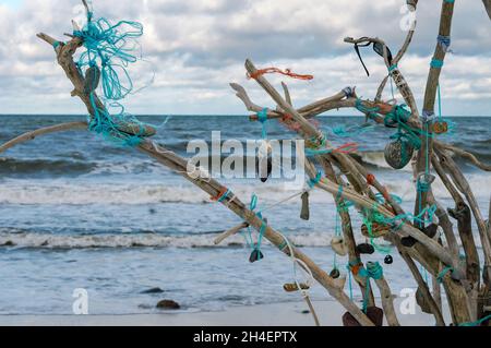 Installation on the seashore. A composition of sticks and stones. Stock Photo