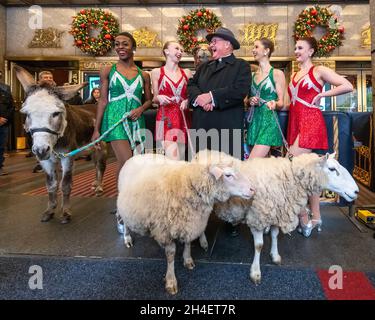 New York, USA. 1st Nov, 2021. Rockettes laugh with New York City's Archbishop Timothy Dolan after he blessed the animals that will appear in a living Nativity scene at the Radio Citiy Music Hall Christmas Spectacular in New York City. The show returns after having been cancelled last year during the pandemic lockdown. Credit: Enrique Shore/Alamy Live News Stock Photo