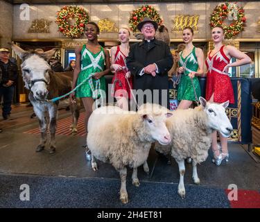 New York, USA. 1st Nov, 2021. Rockettes flank New York City's Archbishop Timothy Dolan after he blessed the animals that will appear in a living Nativity scene at the Radio Citiy Music Hall Christmas Spectacular in New York City. The show returns after having been cancelled last year during the pandemic lockdown. Credit: Enrique Shore/Alamy Live News Stock Photo