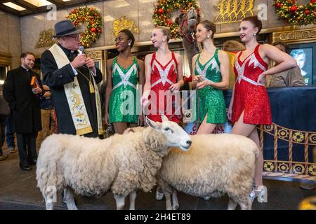 New York, USA. 1st Nov, 2021. Rockettes listen to New York City's Archbishop Timothy Dolan (L) after he blessed the animals that will appear in a living Nativity scene at the Radio Citiy Music Hall Christmas Spectacular in New York City. The show returns after having been cancelled last year during the pandemic lockdown. Credit: Enrique Shore/Alamy Live News Stock Photo