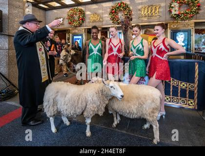 New York, USA. 1st Nov, 2021. Rockettes watch as New York City's Archbishop Timothy Dolan (L) blesses the animals that will appear in a living Nativity scene at the Radio Citiy Music Hall Christmas Spectacular in New York City. The show returns after having been cancelled last year during the pandemic lockdown. Credit: Enrique Shore/Alamy Live News Stock Photo