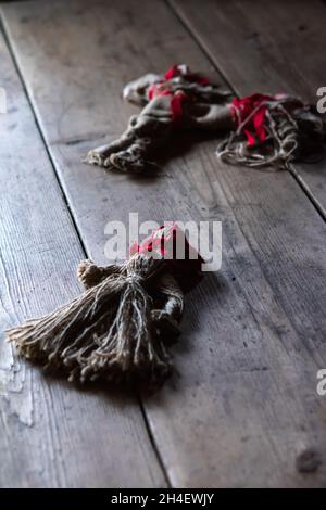 the concept of occultism, a knitted doll on a wooden table Stock Photo