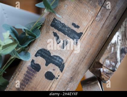 Number 34 stencil printed in black on a wooden plank. Vintage thrity four lettering. Stock Photo