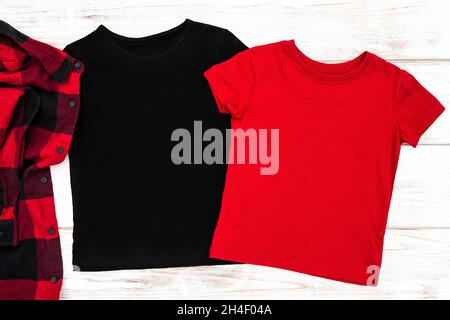 Red and black t-shirt mock up on bright wooden background Stock Photo
