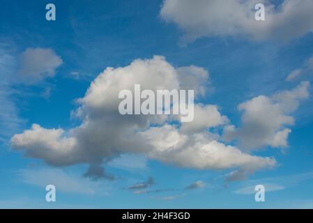 Small group of clouds in a blue sky Stock Photo