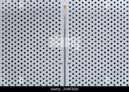 Perforated metal plate as an industrial background Stock Photo