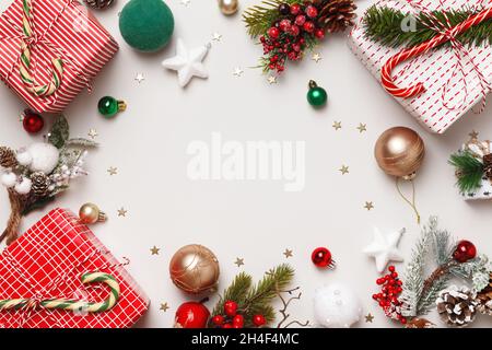New Year's winter composition. Christmas boxes with gifts fir branches balls on a white background. Frame border flat lay top view copy space Stock Photo