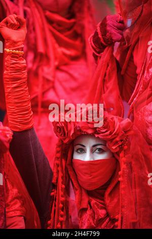 Glasgow Scotland, UK November 02 2021. Extinction Rebellion red robed protesters travel in a procession through the city to the COP 26 barricades behind which world leaders gather to discuss their response to climate change. credit sst/alamy live news Stock Photo