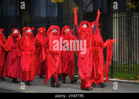 Glasgow Scotland, UK November 02 2021. Extinction Rebellion red robed protesters travel in a procession through the city to the COP 26 barricades behind which world leaders gather to discuss their response to climate change. credit sst/alamy live news Stock Photo