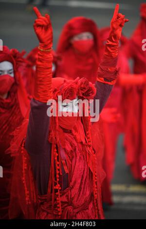 Glasgow Scotland, UK November 02 2021. Extinction Rebellion red robed protesters travel in a procession through the city to the COP 26 barricades behind which world leaders gather to discuss their response to climate change. credit sst/alamy live news Stock Photo