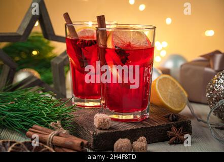 Mulled wine close-up on a Christmas background with burning lights. Side view, close-up. Selective focus. Stock Photo