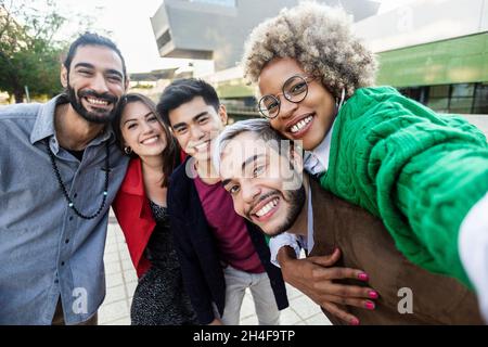 United group of happy multiracial young friends having fun outdoors Stock Photo