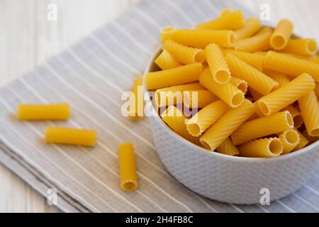 Dry Rigatoni Pasta in a gray Bowl, side view. Copy space. Stock Photo