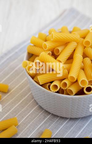 Dry Rigatoni Pasta in a gray Bowl, side view. Stock Photo