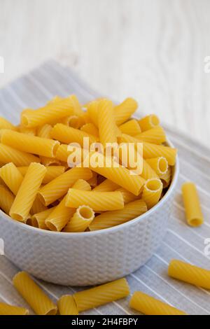 Dry Rigatoni Pasta in a gray Bowl, side view. Stock Photo