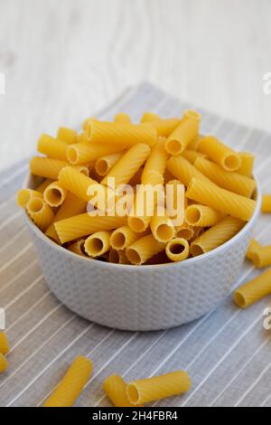 Dry Rigatoni Pasta in a gray Bowl, low angle view. Stock Photo