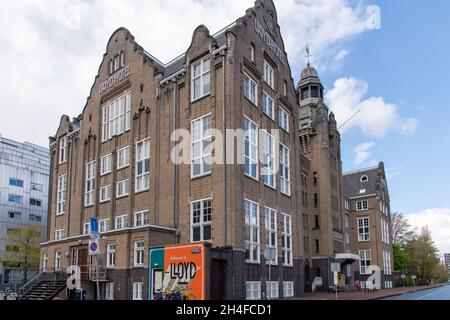 Amsterdam, The Netherlands-May 2021: Low angle view of the 1920's architectural building and monument that was a hotel for emigrants, then a prison Stock Photo