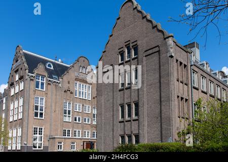 Amsterdam, The Netherlands-May 2021: Low angle view of the 1920's architectural building and monument that was a hotel for emigrants, then a prison Stock Photo