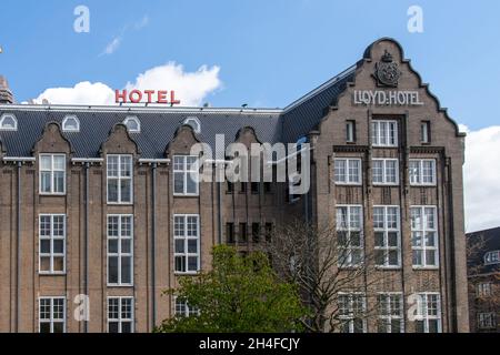 Amsterdam, The Netherlands-May 2021: Low angle view of top floors of 1920'sl building and monument that was a hotel for emigrants, then a prison Stock Photo