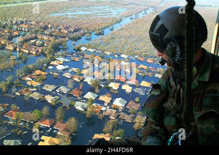 NEW ORLEANS, LOUISIANA, USA - 04 September 2005 - Tech. Sgt. Keith Berry looks down into the flooded streets of New Orleans to search for survivors. H