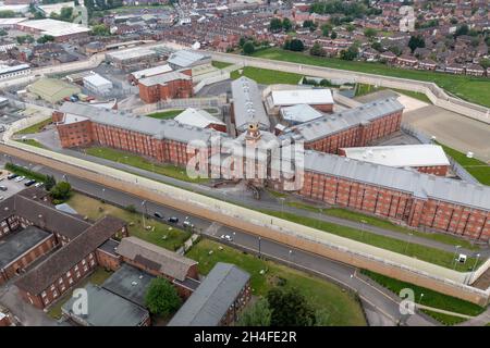 Aerial drone footage of the town centre of Wakefield in West Yorkshire in the UK showing the main building and walls of Her Majesty's Prison Stock Photo
