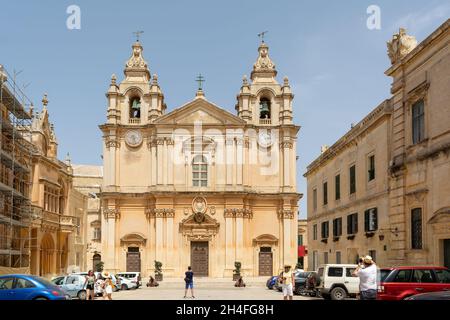 Tourists wandering at St. Paul's Square before entrance to St Paul's Cathedral, built in Baroque style, with influences from native Maltese architectu Stock Photo