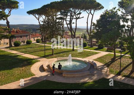 High-angle view of Piazzale Belvedere public garden with the fountain and maritime pines in summer, Castagneto Carducci, Livorno, Tuscany, Italy Stock Photo