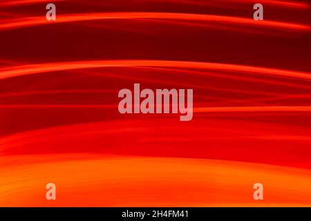 Horizontal abstract bright red wavy background with a gradient fading from orange to maroon. Beautiful backdrop. Stock Photo