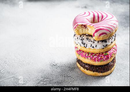 Stack of artisan donuts. White background. Top view. Copy space Stock Photo