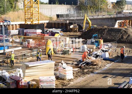 Construction workers working on sunny day at new housing development plot Greenwich London England UK Stock Photo