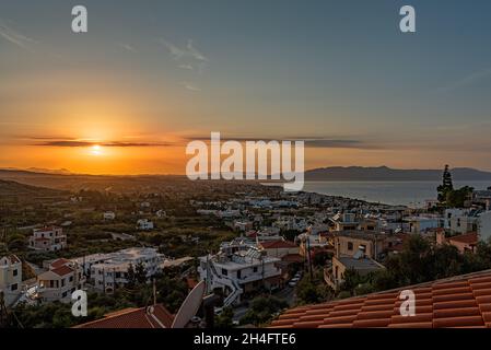Sunset over Platanias village and bay from a high viewpoint, Crete, Greece, October 10, 2021 Stock Photo